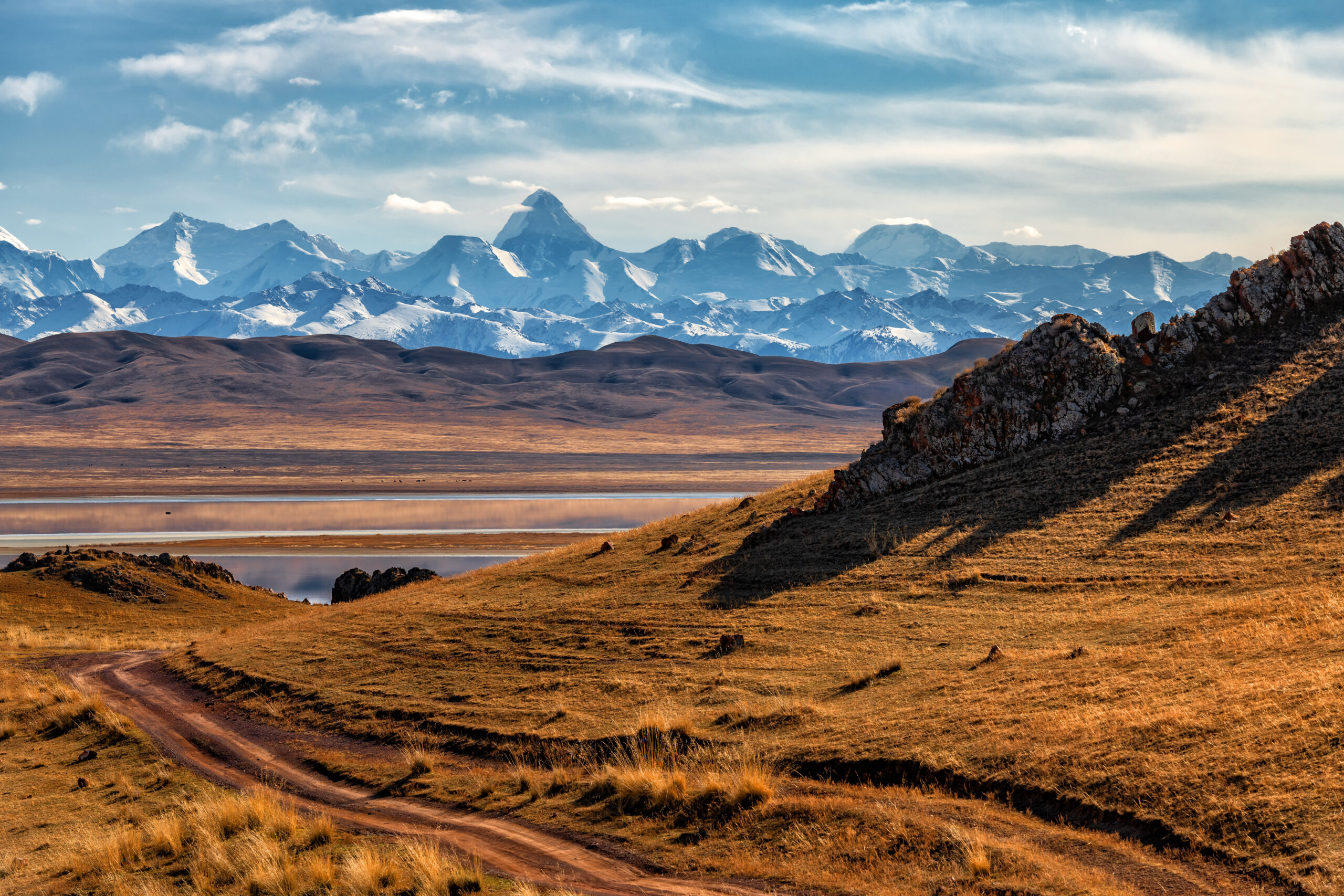 Northern Tien Shan mountain range with Khan Tengri peak in southeast Kazakhstan under a cloudy sky